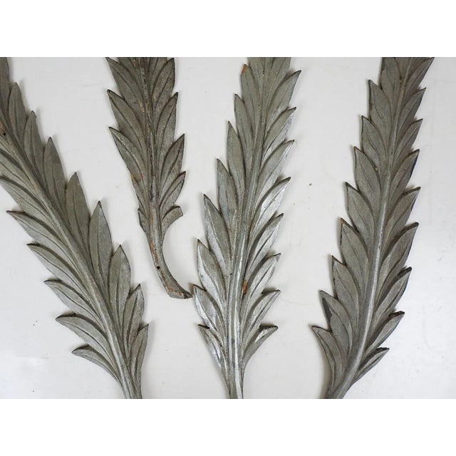 Early 1900's set of 4 hand carved folk art leaves painted silver. From an Odd Fellows Lodge, holes where they were nailed...