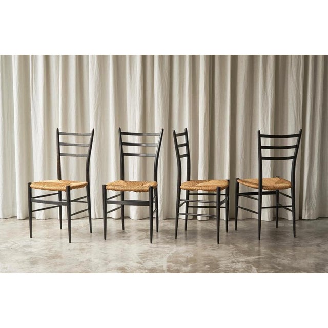Fratelli Spinetto Chiavari Set of 4 Dining Chairs in Ebonized Wood and Straw, Italy, 1950s. A very elegant and minimalist...