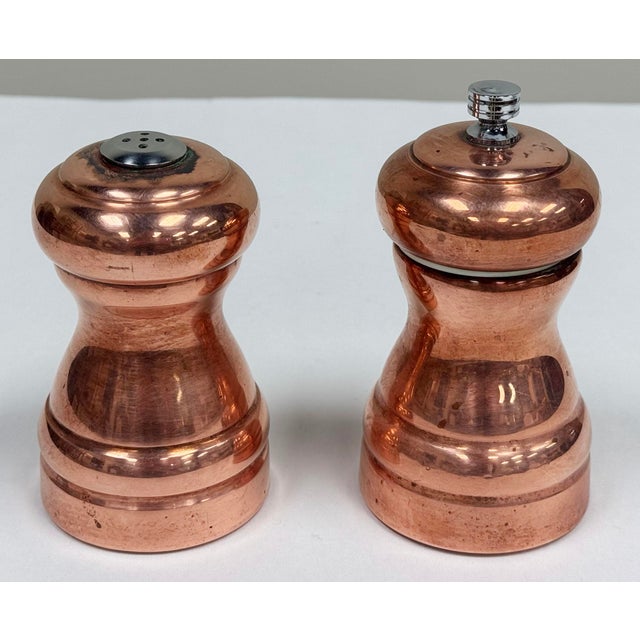 Vintage set of "Olde Thompson" copper pepper mill and salt shaker. Copper finish over a durable body on both pieces....
