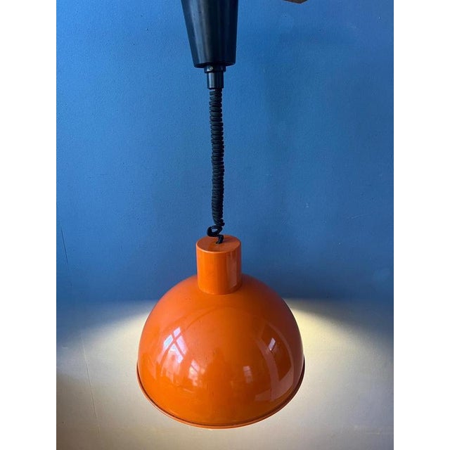Orange Fog & Mørup enamel 'bunker' pendant lamp by Joe Hammerborg. The lamp is made out of metal and has an orange...