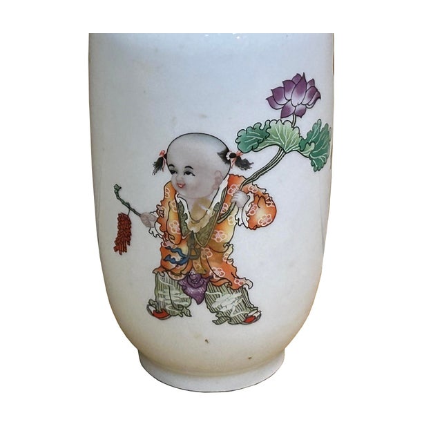 This elegant porcelain vase features a classic ovoid silhouette with a gently flared rim, serving as a pristine canvas for...