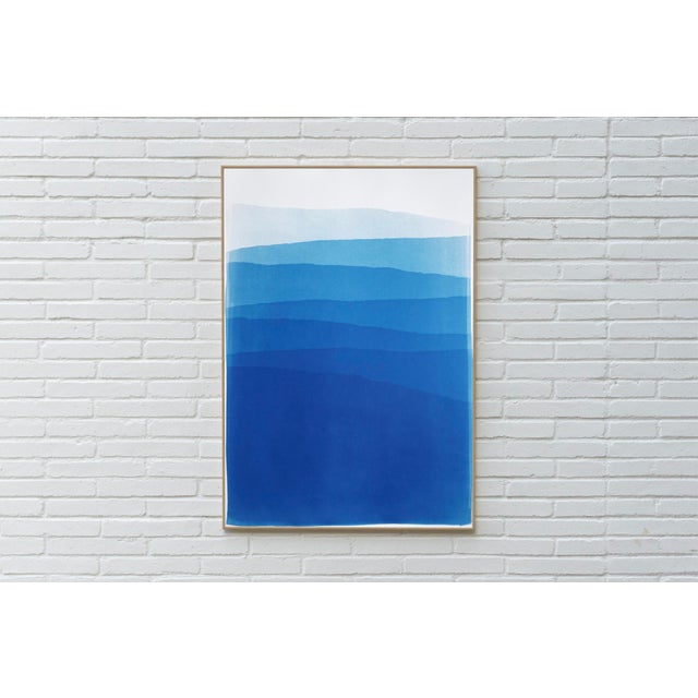 Blue Mountains is a handmade cyanotype monotype that presents a quiet landscape of layered mountain forms in soft shades...