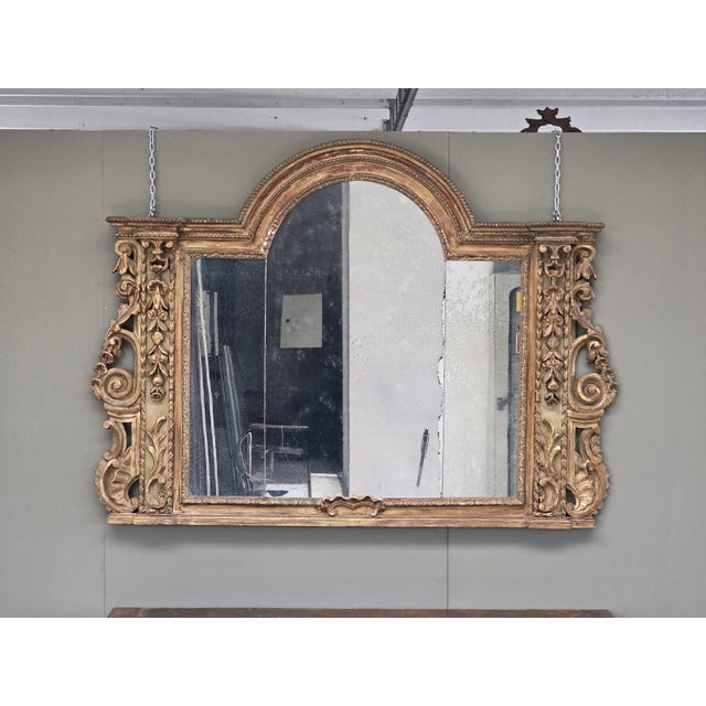 An important mantelpiece in finely carved and gold-leaf gilded wood, made in Northern Italy between the late 17th and...