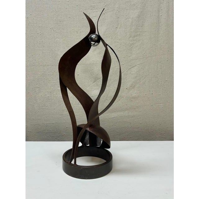 Abstract metal sculpture with chrome ball pinnacle. Unsigned. Heavy.