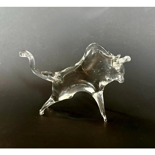 Striking vintage blown glass bull figurine with a sleek, stylized form. This midcentury piece captures the strength and...