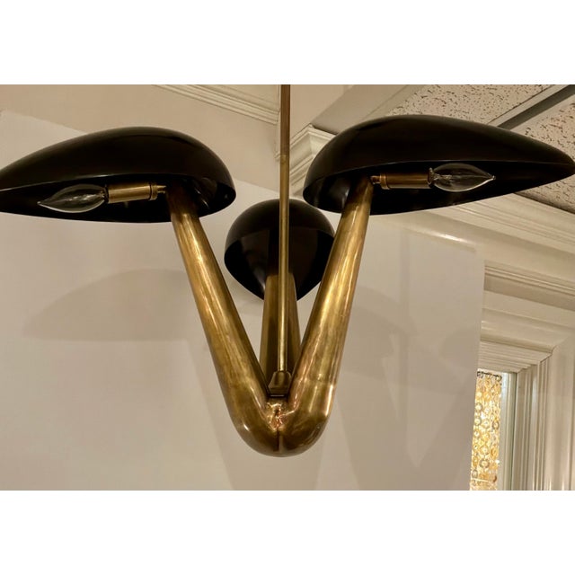 Original retail $1915, stylish Arteriors Modern Black and Gold Everglades Chandelier, showroom floor sample