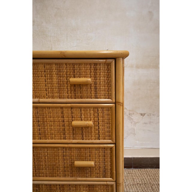 1970s chest of drawers featuring a bamboo structure with drawer fronts covered in woven rush. Fitted with four spacious...