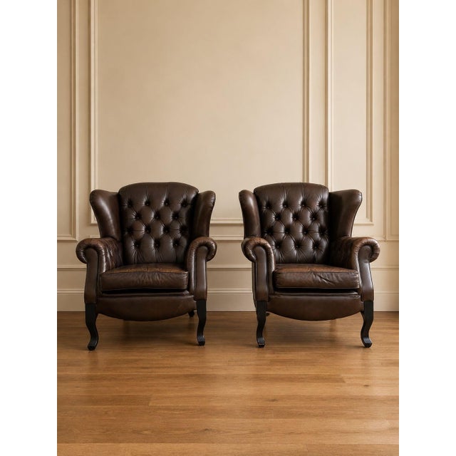 Pair of Mid-Century European Chesterfield-Style Tufted Leather Lounge Chairs, circa 1960s Description: A striking pair of...