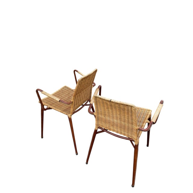 A Rare French Midcentury Modern hand stitched leather and rattan armchairs by Jacques Adnet, circa 1955. Adnet had a rare...