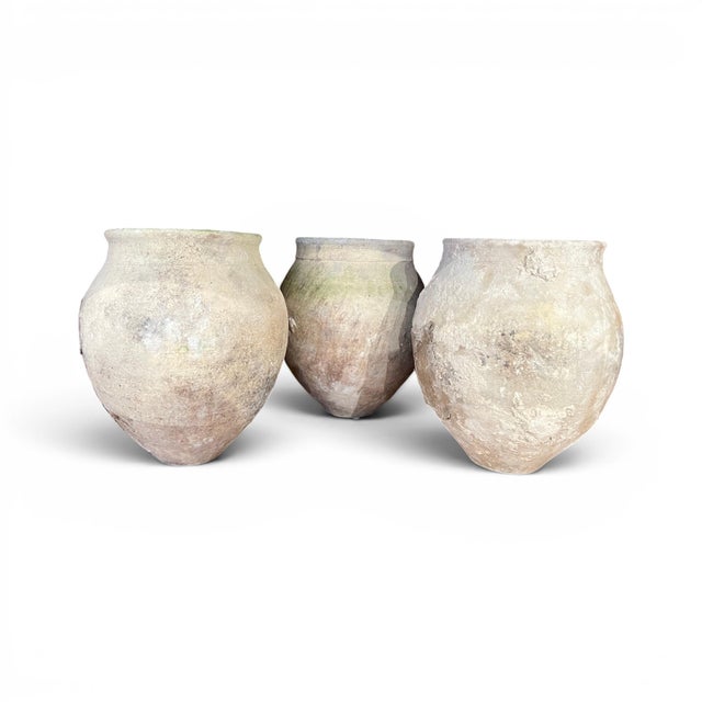 This rustic set of three 18th century Spanish jars showcases the beauty of handcrafted pottery, with each vessel featuring...