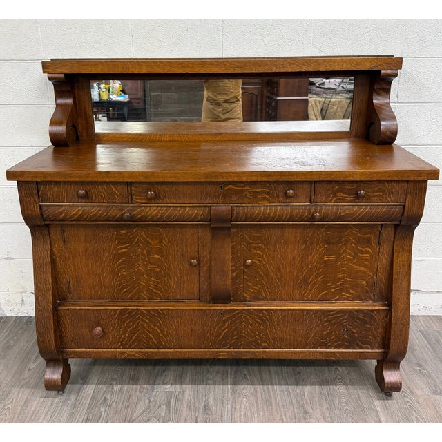 This is a gorgeous antique Empire tiger oak sideboard, server, or buffet crafted in richly figured quarter-sawn white oak....