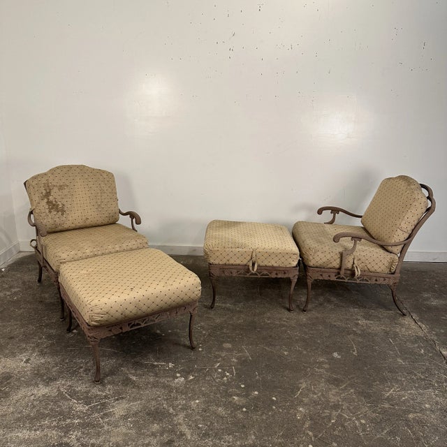 Pair of Woodard outdoor cast metal patio lounge chairs with matching ottomans. The chairs themselves are not marked but...