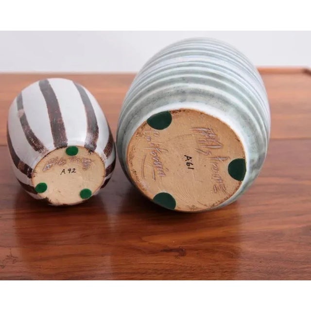 Mint set of of two ceramic vases by Ahlstrom. Very nice glaziers. The size is the bigger green striped one. This piece is...