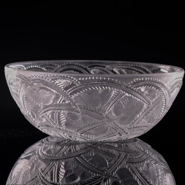 A signed Lalique France crystal bowl in the Pinsons pattern, featuring frosted birds and foliage in relief against a clear...