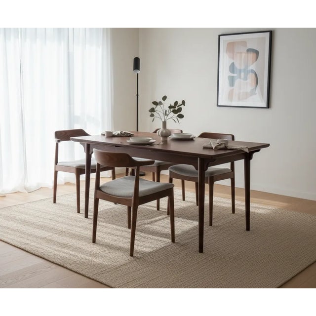 A beautifully crafted rosewood dining table designed by Gunni Omann for Omann Jun Mobelfabrik. This high-quality piece...