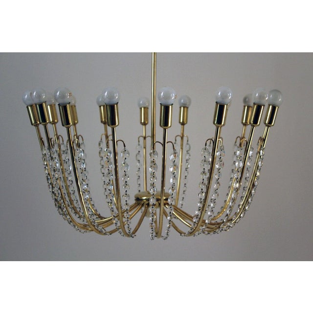 This huge Kalmar brass chandelier, model number 3747 "Alpha", features chains of hand-cut crystals. - Height of the body...