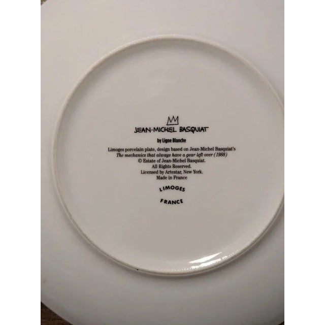 Jean-Michel Basquiat, The mechanics that always have a gear left over - 1988. Limited edition Limoges porcelain plate,...