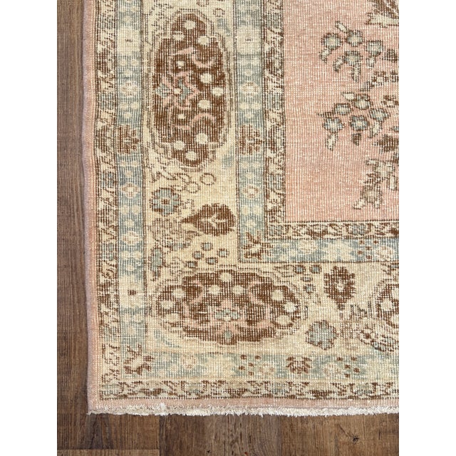 A lovely vintage oushak rug with blush and blue acccents.