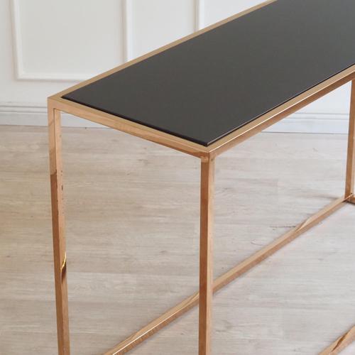 Open contemporary console, newly produced, with a clean-lined bronze-colored frame and a black top. The strictly...