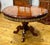 Make a sophisticated statement with this grand round dining table, featuring a richly finished wood surface with intricate...