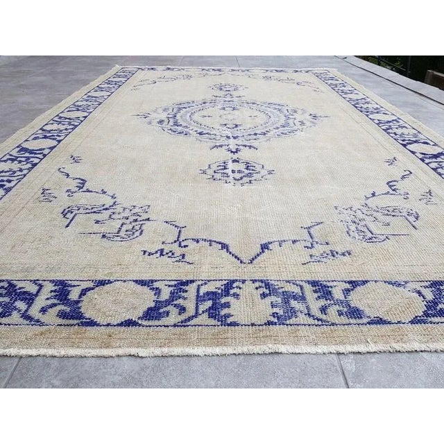 A Turkish handmade vintage Anatolian Oushak rug. We collect old vintage antique rugs from Anatolia, which is the eastern...