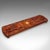 This is an antique Cribbage board. An English, inlaid game scoreboard with pin storage in mahogany and bird's eye maple,...