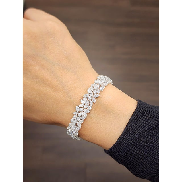 This stunning bracelet embodies modern sophistication. Featuring an array of mixed-cut natural white diamonds, each stone...