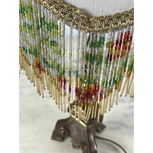 Bronze table lamp, Italian production of the 60s. Lady of the time, discreet conditions, missing some threads in the edge....