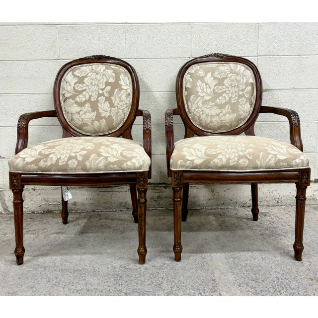 This is a stunning pair of vintage French Louis XVI style arm chairs or Bergere chairs with beautiful carvings by...