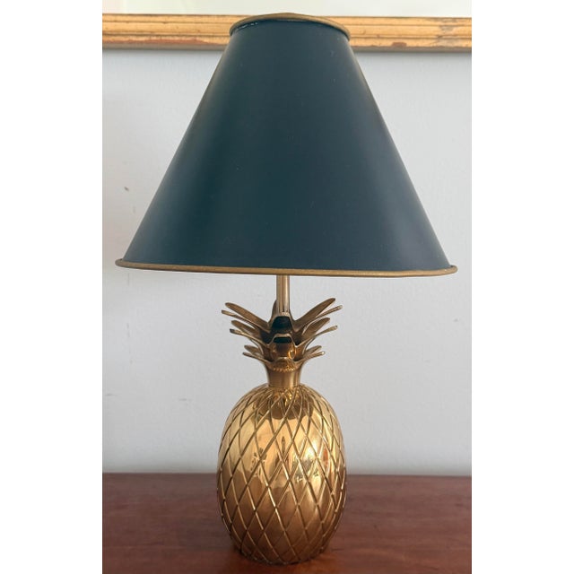 Petite brass pineapple lamp with black tole metal shade than has a gold interior. Small lamps are always so useful. Solid...