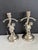 A charming pair of antique silver-plated figural candlesticks, each sculpted as a cherub child entwined with a...
