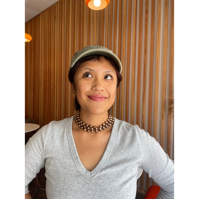 This is a stunning triple strand of bronze pearls. They look incredibly elegant when worn with the right ensemble.