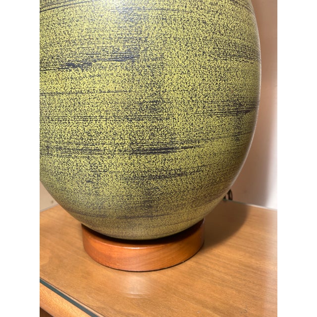 This is a pair of large Mid-Century pottery lamps. The striated green glazes are truly gorgeous. The base and accent at...