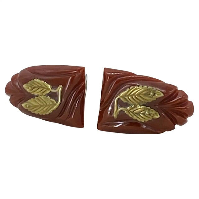 This is a pair of Art Deco style Bakelite dress clips. These maroon color carved Bakelite dress clips are decorated with...