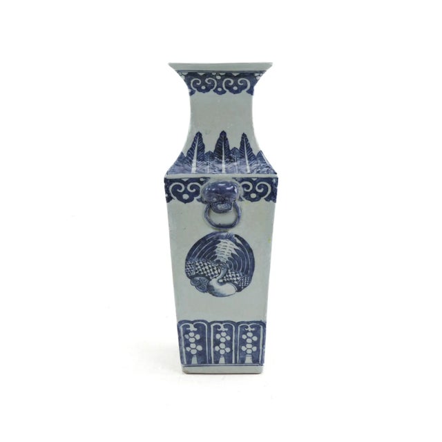 This antique Chinese blue and white porcelain vase features a striking square form with intricate hand-painted designs. A...