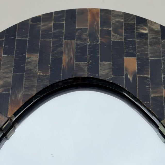 A striking vintage oval wall mirror by Enrique Garcel, Colombia, marked Made in Colombia on the back, as all of his pieces...