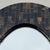 A striking vintage oval wall mirror by Enrique Garcel, Colombia, marked Made in Colombia on the back, as all of his pieces...