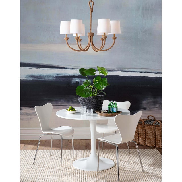 Natural woven rattan provides a "washed ashore" look on the Bimini chandelier. Looped detailing also provides a nautical...