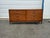 A handsome vintage Mid-Century Modern walnut credenza / dresser featuring warm wood tones, clean architectural lines, and...