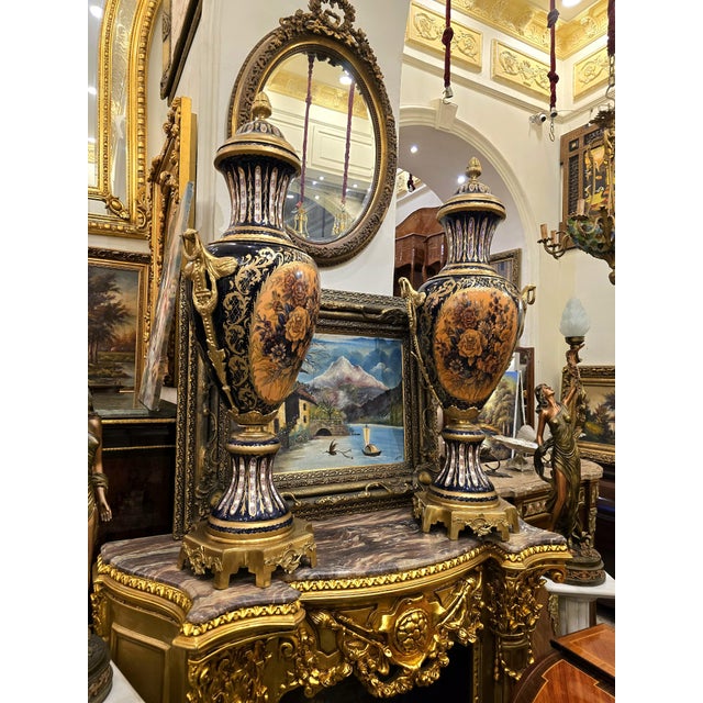 This elegant French style porcelain vase features a rich deep blue finish beautifully accented with white and gold...
