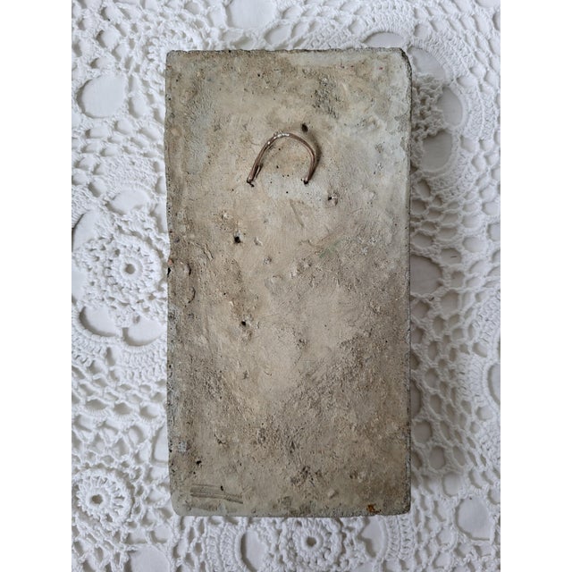 A cast cement decorative door sculpture that has been embellished with gold (likely Rub'n Buff). It measures 7 ¼” x 3 ¾” x...