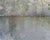 This oil painting captures a serene landscape where soft shades of gray blend harmoniously with hints of green, reflecting...