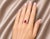 Elegant 14K white gold cocktail ring featuring one natural oval ruby nearly 1 carat surrounded by brilliant round diamonds...