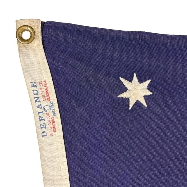 This vintage American Bennington flag is made from a cotton cloth, with fully embroidered emblem and sewn stripes. Please...