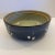 A richly glazed vintage studio pottery bowl with a deep cobalt-blue exterior and loose, hand-painted botanical decoration...