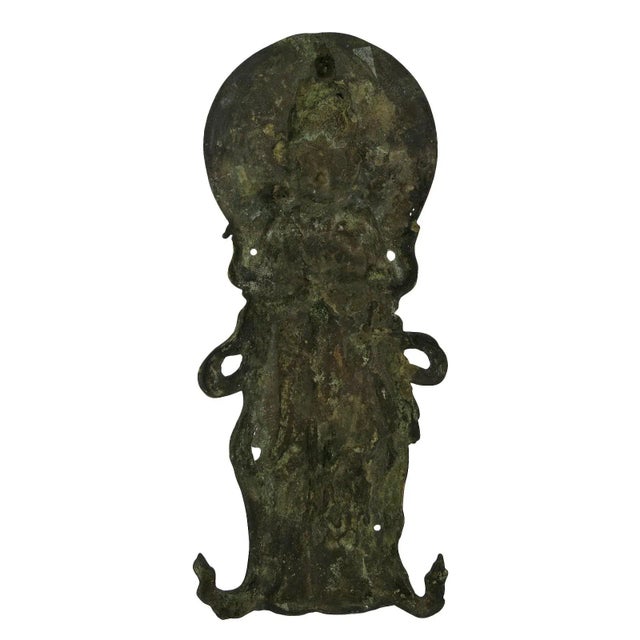 An Eighteenth Century deep richly patinated relief plaque depicting a Diety. The figure is modeled in high relief dressed...