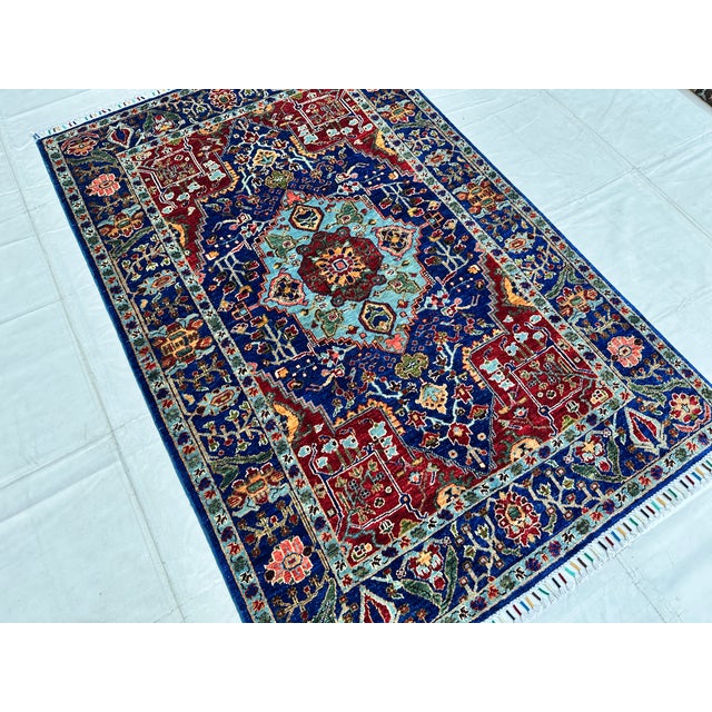 Caucasian Karachoph Kazak design hand-knotted rug featuring a bold stepped octagonal medallion in sky blue with a crimson...