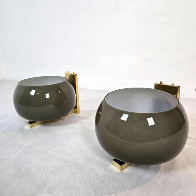 Pair of glass and brass mid century modern wall sconces, Italy 1980s. The Italian sconces are made of polished brass...