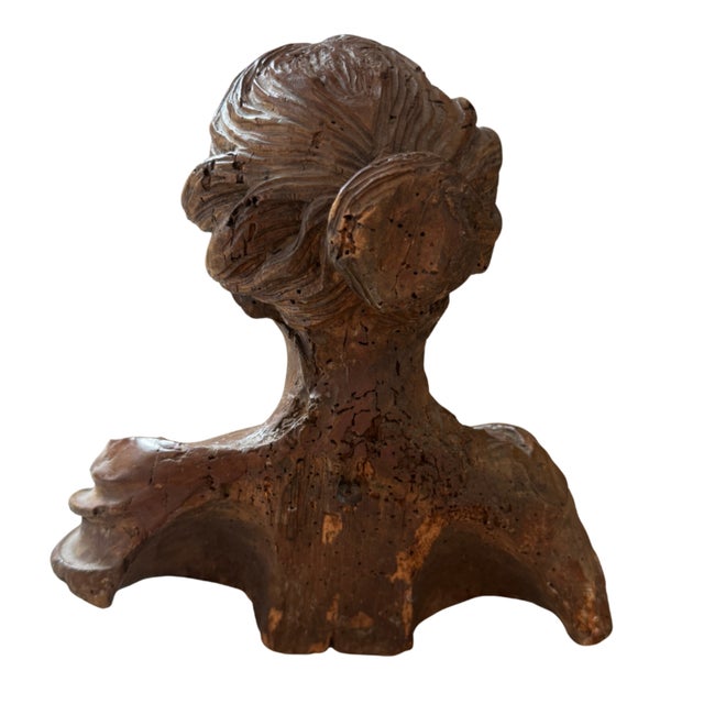 A hand carved portrait bust of a woman from 17th century Europe, made from wood, probably lime wood, and finished in...