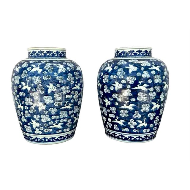 Pair of Chinese Blue and White Baluster Chinese Baluster Jars With Cranes. Jars feature rich, cobalt blue backgrounds with...